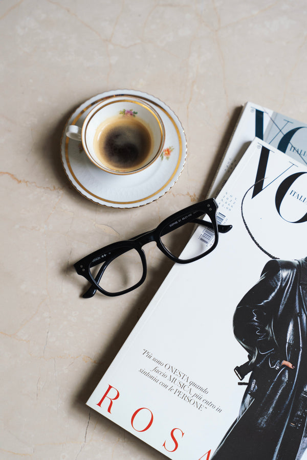 Eyeglasses next to coffee